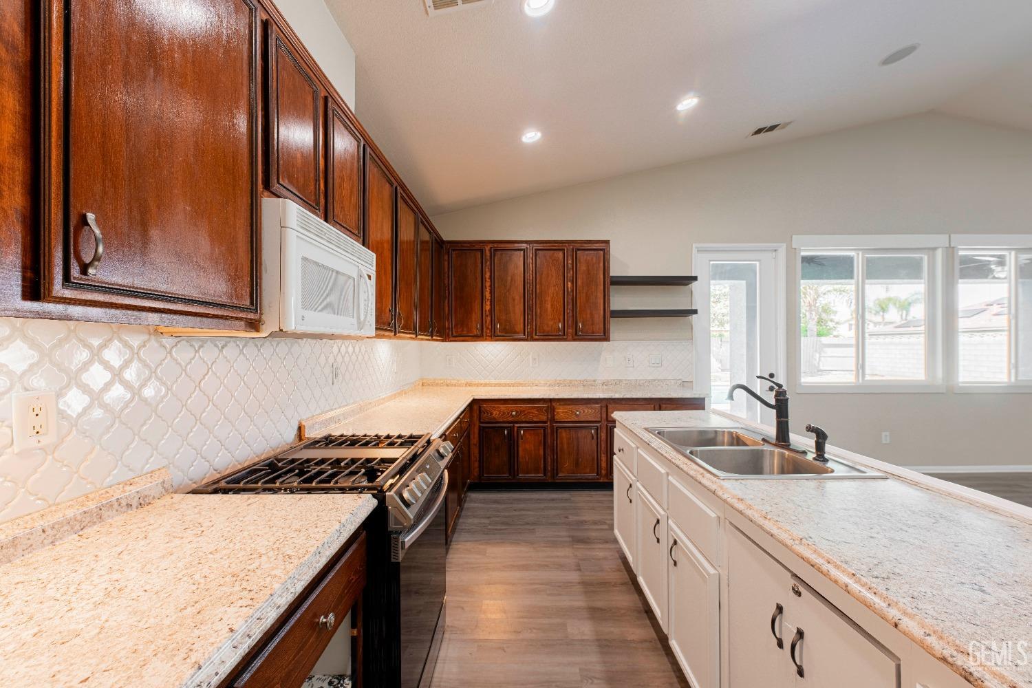 Undisclosed Address Bakersfield, CA 93312 - Photo 15 of 44 a kitchen with stainless steel appliances granite countertop a sink stove and cabinets