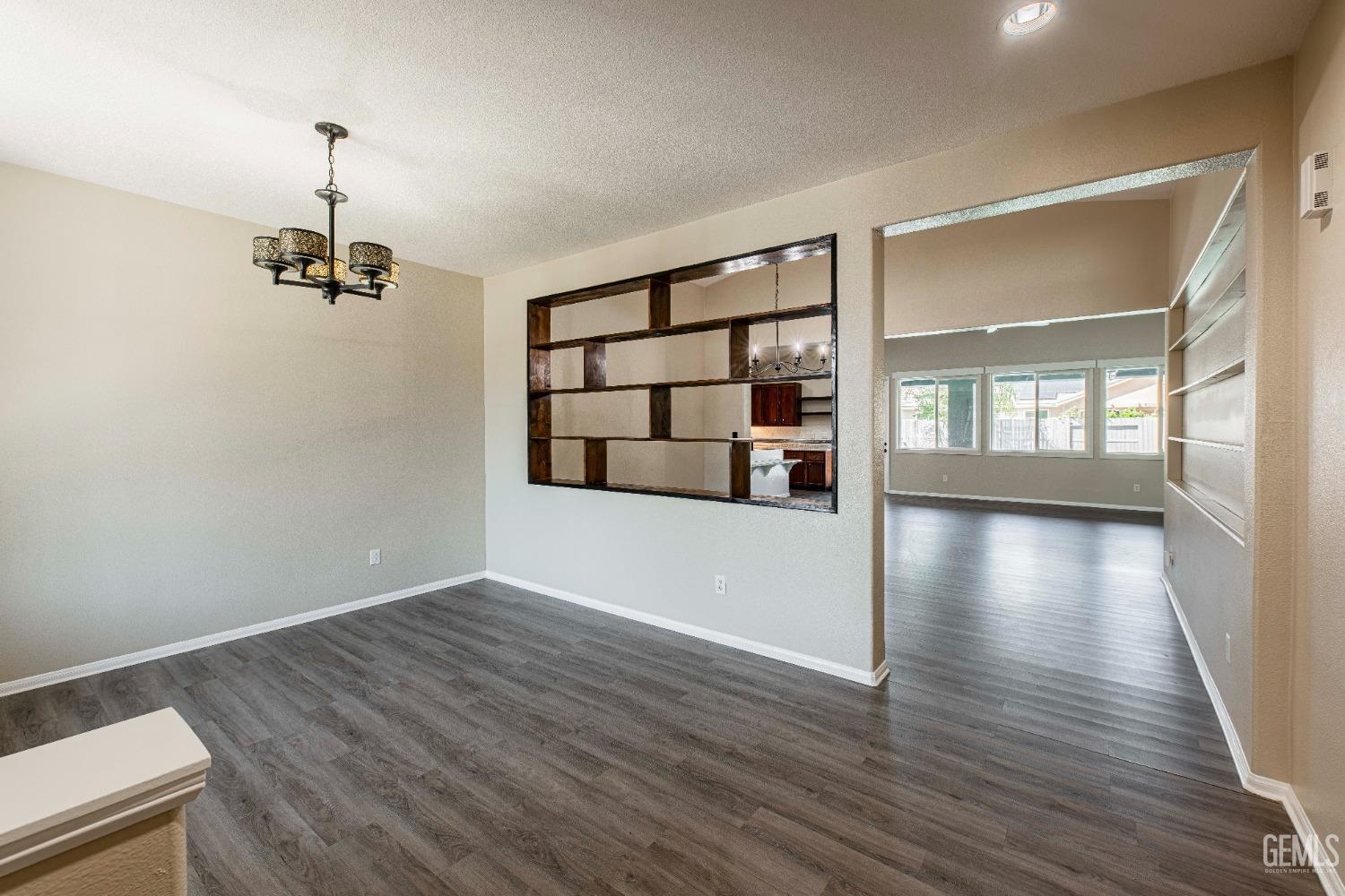 Undisclosed Address Bakersfield, CA 93312 - Photo 2 of 44 wooden floor in an empty room with a window