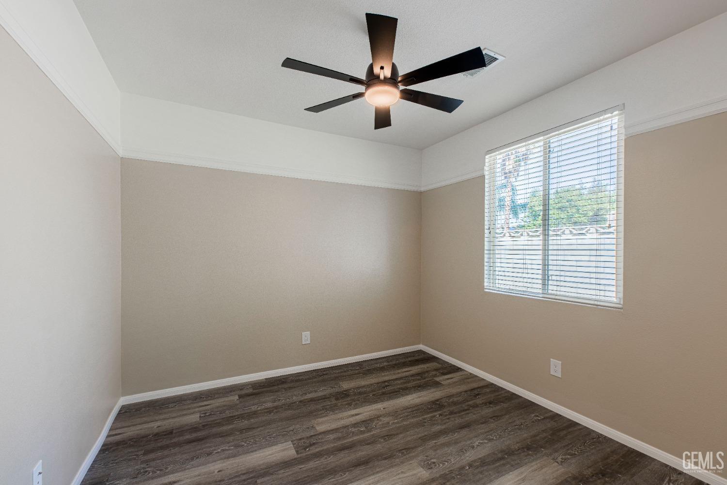 Undisclosed Address Bakersfield, CA 93312 - Photo 24 of 44 a view of an empty room with wooden floor and a window