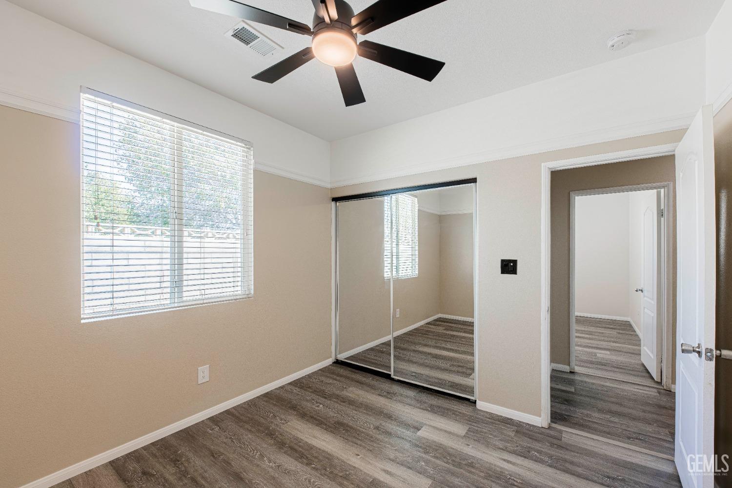 Undisclosed Address Bakersfield, CA 93312 - Photo 25 of 44 a view of an empty room with wooden floor and a window