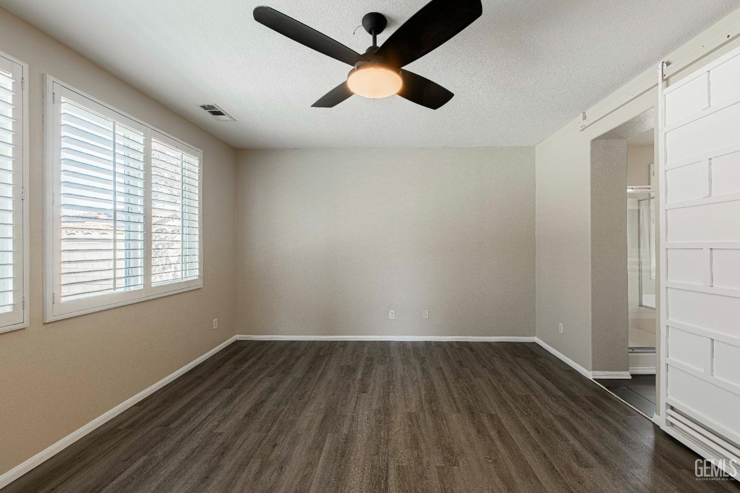 Undisclosed Address Bakersfield, CA 93312 - Photo 29 of 44 wooden floor in an empty room with a window