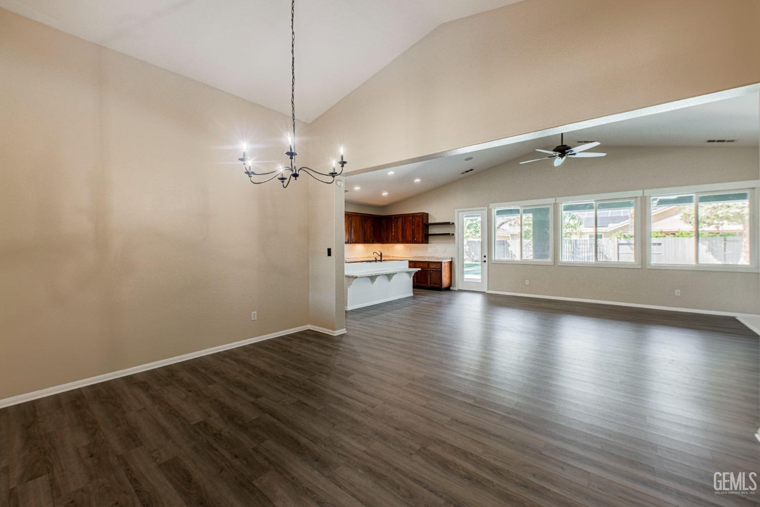 Undisclosed Address Bakersfield, CA 93312 - Photo 5 of 44 a view of a room with wooden floor and a kitchen