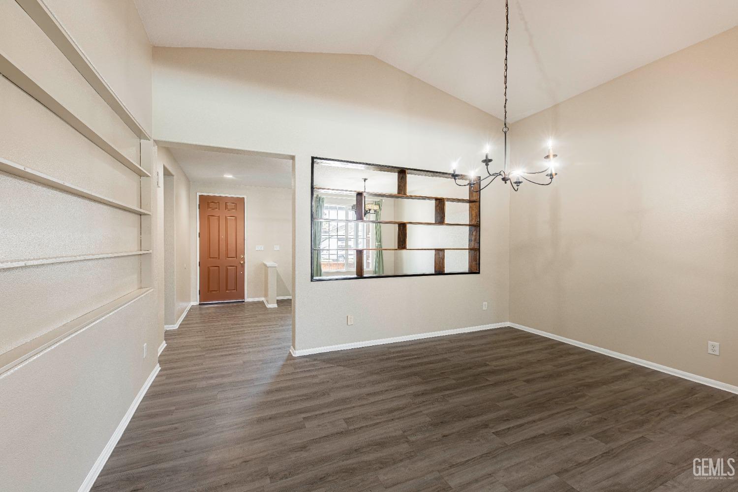 Undisclosed Address Bakersfield, CA 93312 - Photo 7 of 44 a view of an empty room with wooden floor and a window