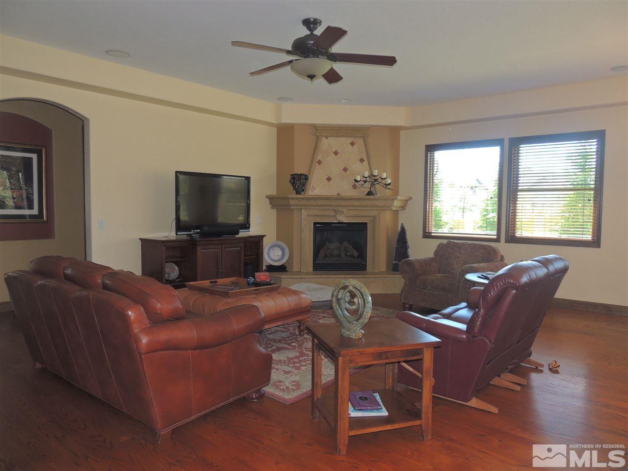 1205 Springer Court Reno, NV 89511 - Photo 4 of 6 a living room with furniture a fireplace and a flat screen tv