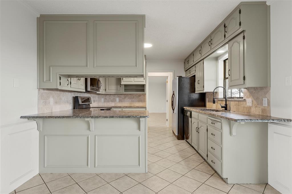 608 South Colorado Street Whitney, TX 76692 - Photo 11 of 27 a kitchen with stainless steel appliances granite countertop a sink and cabinets