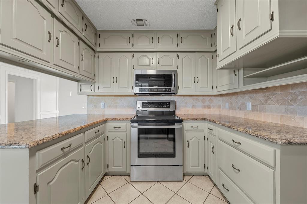 608 South Colorado Street Whitney, TX 76692 - Photo 13 of 27 a kitchen with white cabinets appliances and a sink
