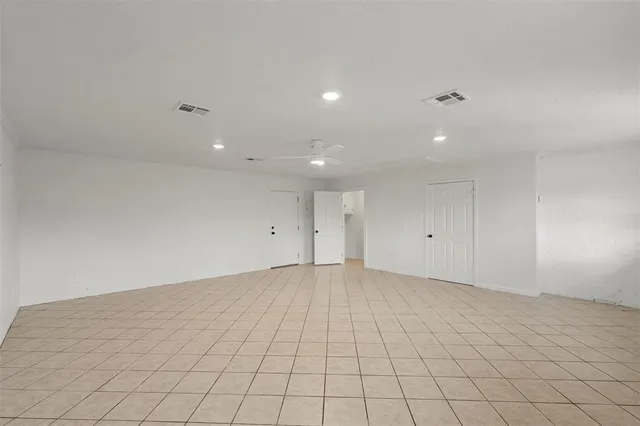 an empty room with white walls and tiles