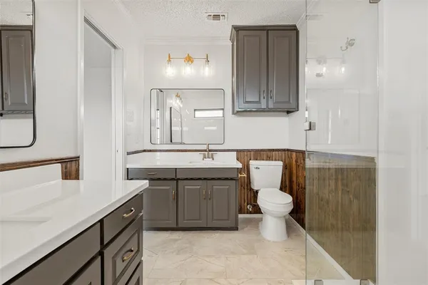 a bathroom with a sink a toilet and mirror