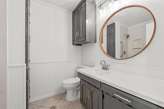 a bathroom with a sink a toilet and a mirror