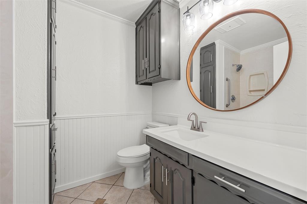 608 South Colorado Street Whitney, TX 76692 - Photo 21 of 26 a bathroom with a sink a toilet and a mirror