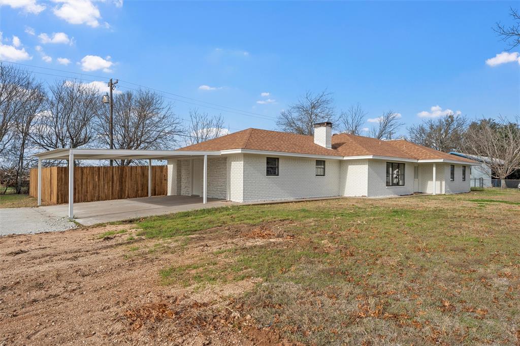 608 South Colorado Street Whitney, TX 76692 - Photo 24 of 27 a front view of a house with a garden