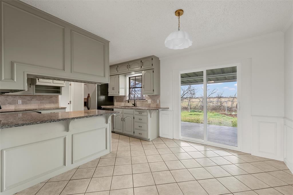 608 South Colorado Street Whitney, TX 76692 - Photo 8 of 26 a kitchen with a stove a sink dishwasher a refrigerator and white cabinets with wooden floor