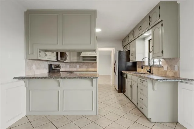 a kitchen with stainless steel appliances granite countertop a sink and cabinets