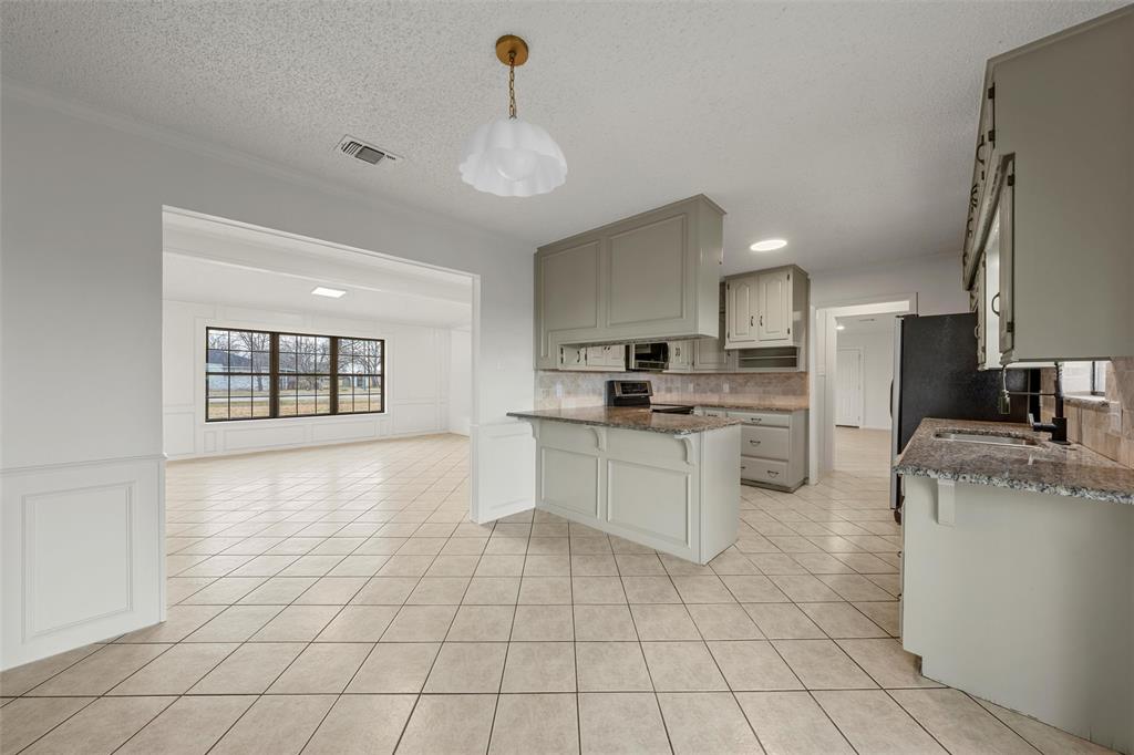 608 South Colorado Street Whitney, TX 76692 - Photo 10 of 27 a kitchen with white cabinets and appliances
