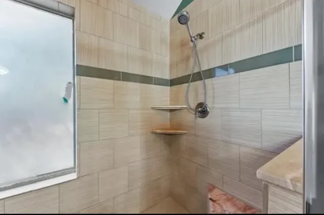 a view of a backyard with wooden fence