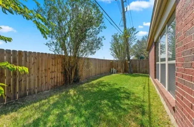 a view of house with backyard