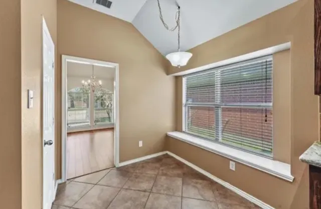 a large kitchen with granite countertop stainless steel appliances stove sink and cabinets