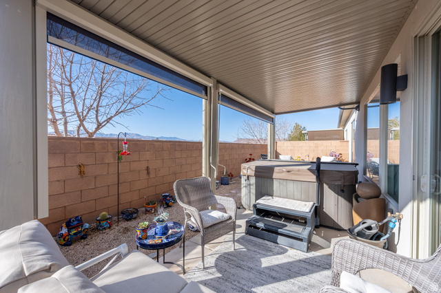 4708 Martin Drive St. George, UT 84790 - Photo 25 of 28 Fenced backyard with a hot tub, a patio, a mountain view, and an outdoor hangout area