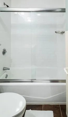 a bathroom with a shower and a sink