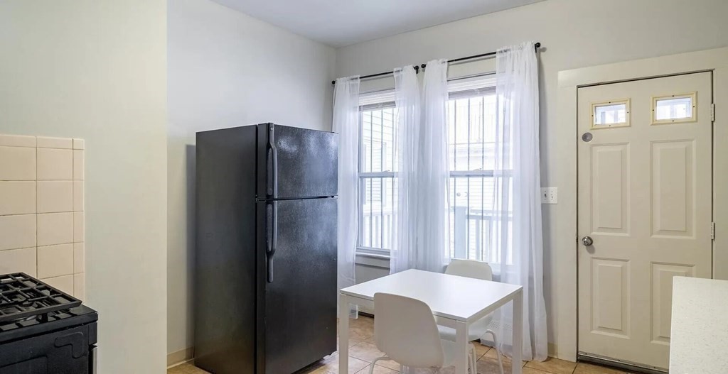 96 East Cottage Street, Unit 2 Boston, MA 02125 - Photo 4 of 15 a kitchen with a refrigerator and a sink