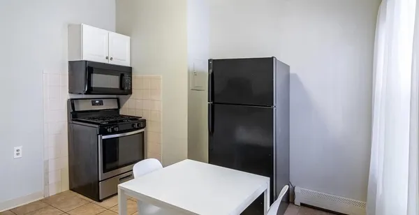 a kitchen with a refrigerator stove and microwave