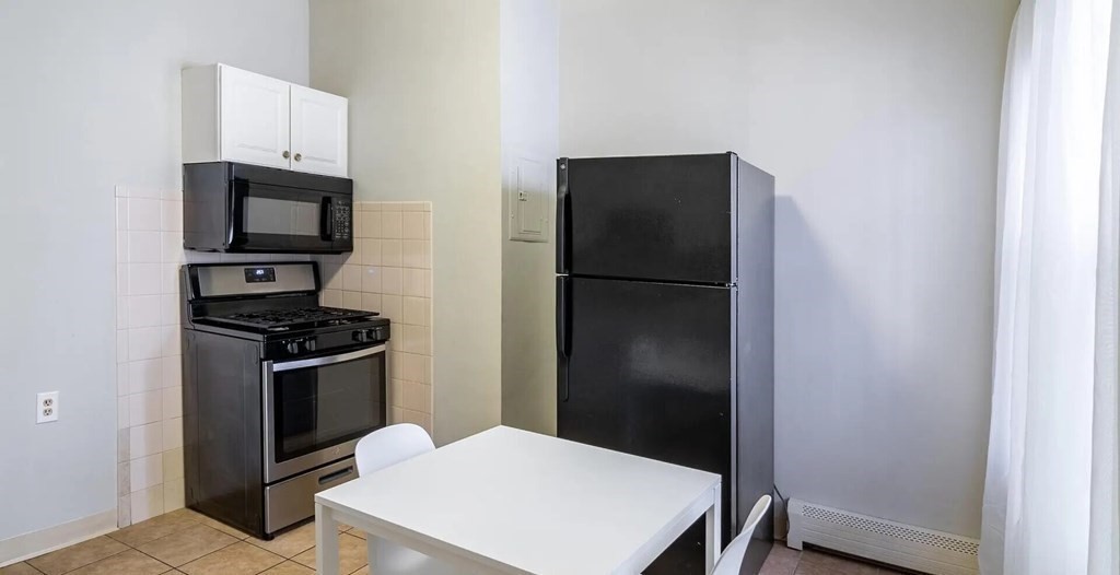 96 East Cottage Street, Unit 2 Boston, MA 02125 - Photo 5 of 15 a kitchen with a refrigerator stove and microwave
