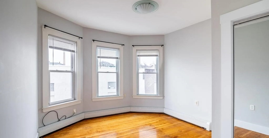 96 East Cottage Street, Unit 2 Boston, MA 02125 - Photo 6 of 15 an empty room with windows