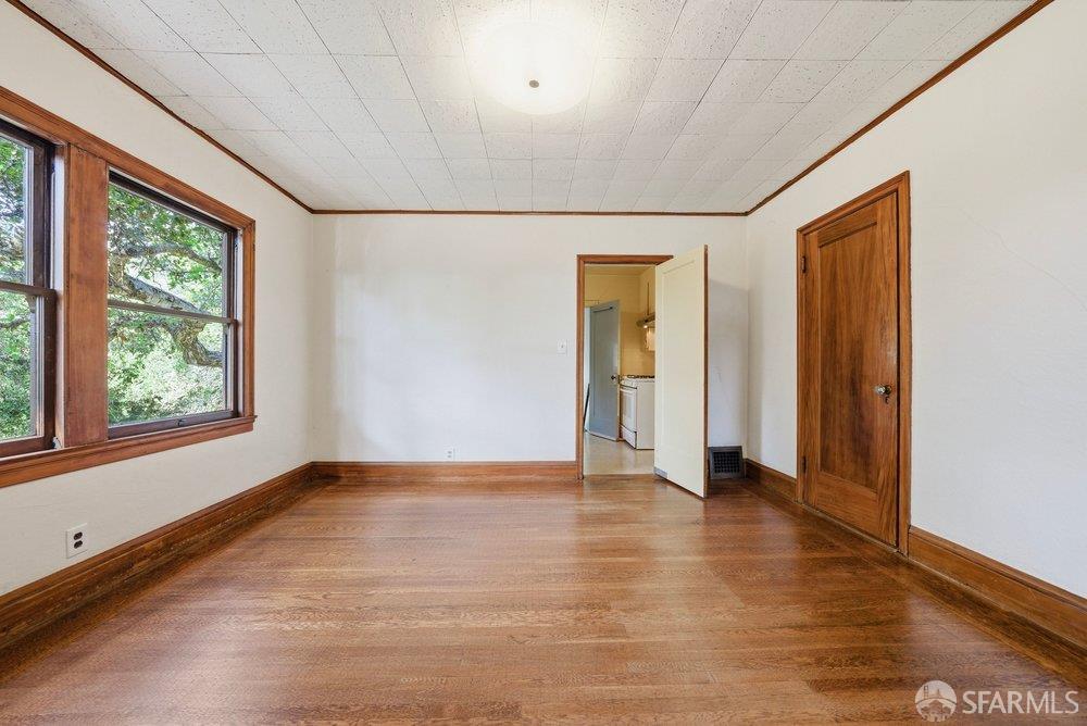 451 Vincente Avenue Berkeley, CA 94707 - Photo 21 of 66 a view of an empty room with window and wooden floor