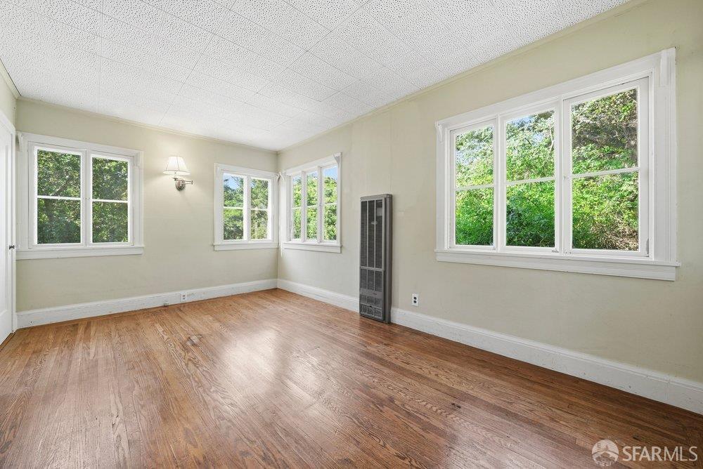 451 Vincente Avenue Berkeley, CA 94707 - Photo 29 of 66 a view of an empty room with wooden floor and a window