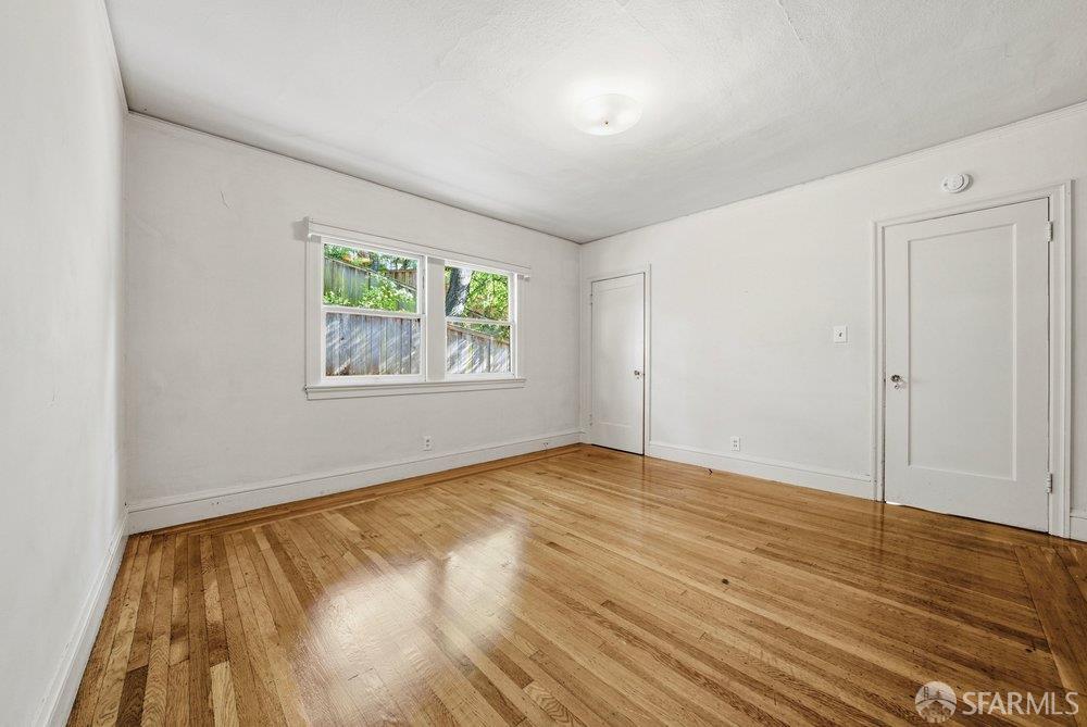 451 Vincente Avenue Berkeley, CA 94707 - Photo 34 of 66 an empty room with wooden floor and windows