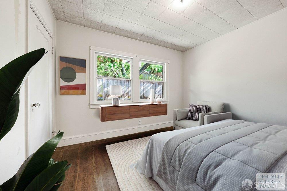 451 Vincente Avenue Berkeley, CA 94707 - Photo 37 of 66 a bedroom with a large bed and a large window with outer view