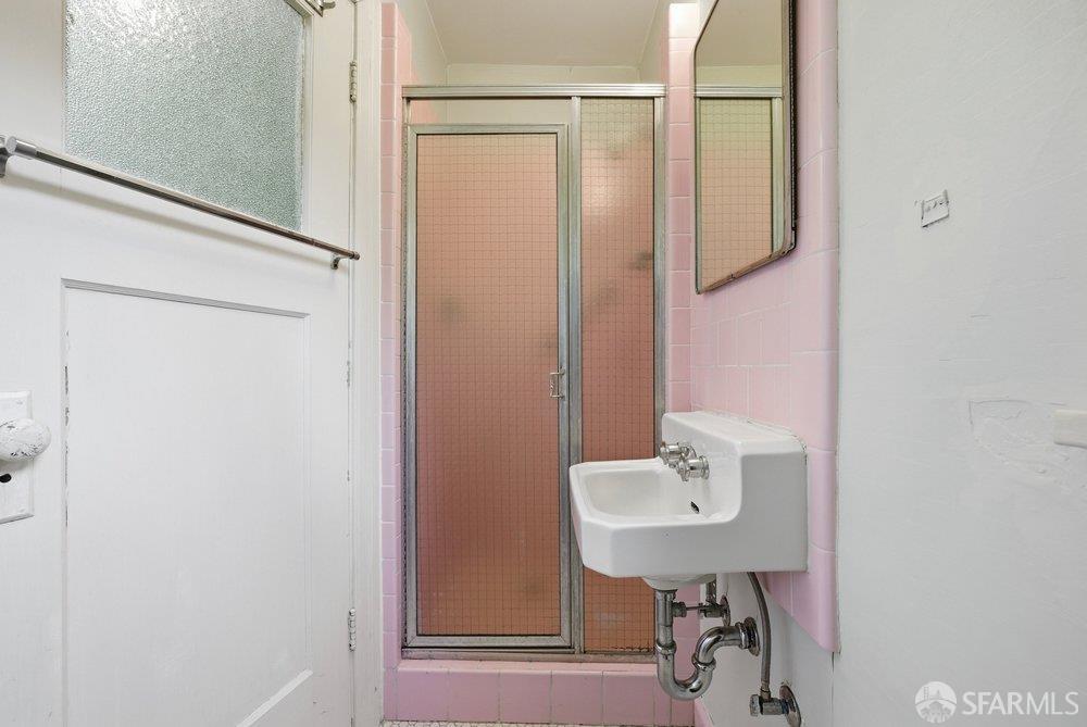 451 Vincente Avenue Berkeley, CA 94707 - Photo 47 of 66 a bathroom with a sink a mirror and shower