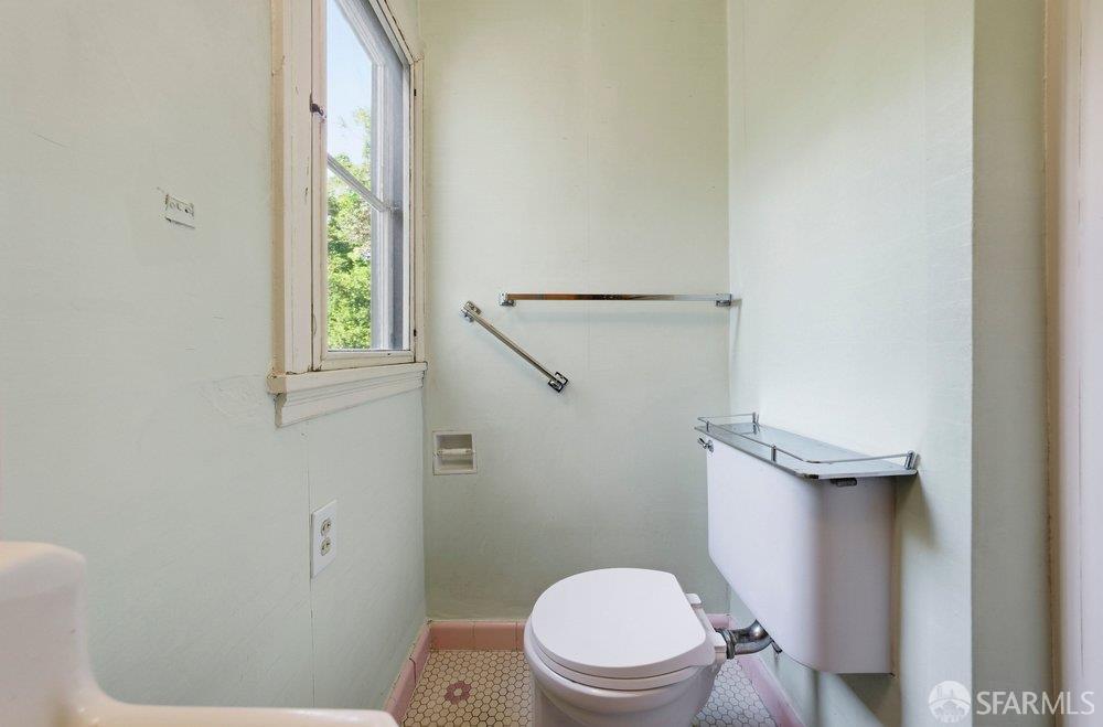 451 Vincente Avenue Berkeley, CA 94707 - Photo 48 of 66 a white toilet sitting next to a bathroom sink and a window