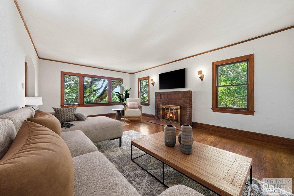 451 Vincente Avenue Berkeley, CA 94707 - Photo 7 of 66 a living room with furniture a flat screen tv and a fireplace