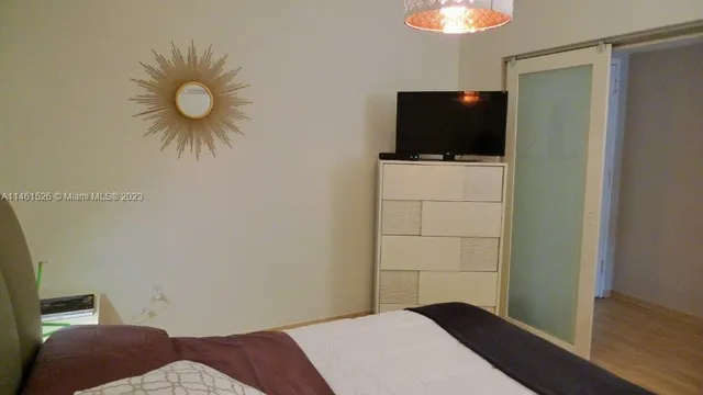 a bedroom with a bed and a flat screen tv