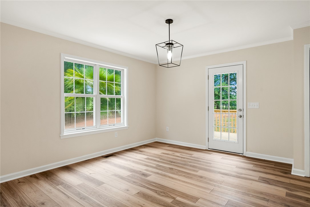 131 Lockaby Road Pelzer, SC 29669 - Photo 21 of 50 This bright space offers rich wood flooring and a refreshing view of nature.