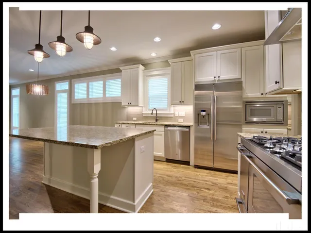 a kitchen with a sink stainless steel appliances and cabinets