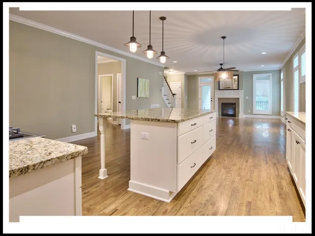 a open kitchen with granite countertop a sink window and cabinets