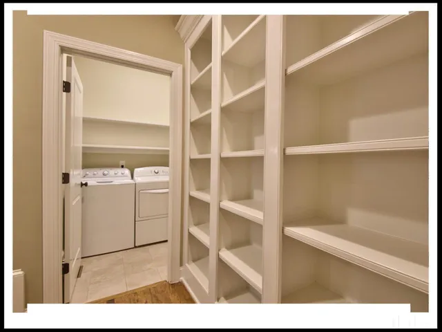 a view of walk in closet with empty racks
