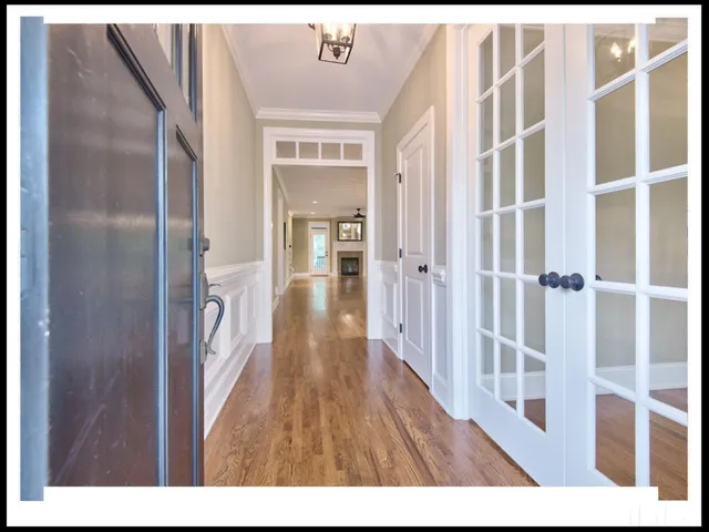 a view of a hallway with wooden floor