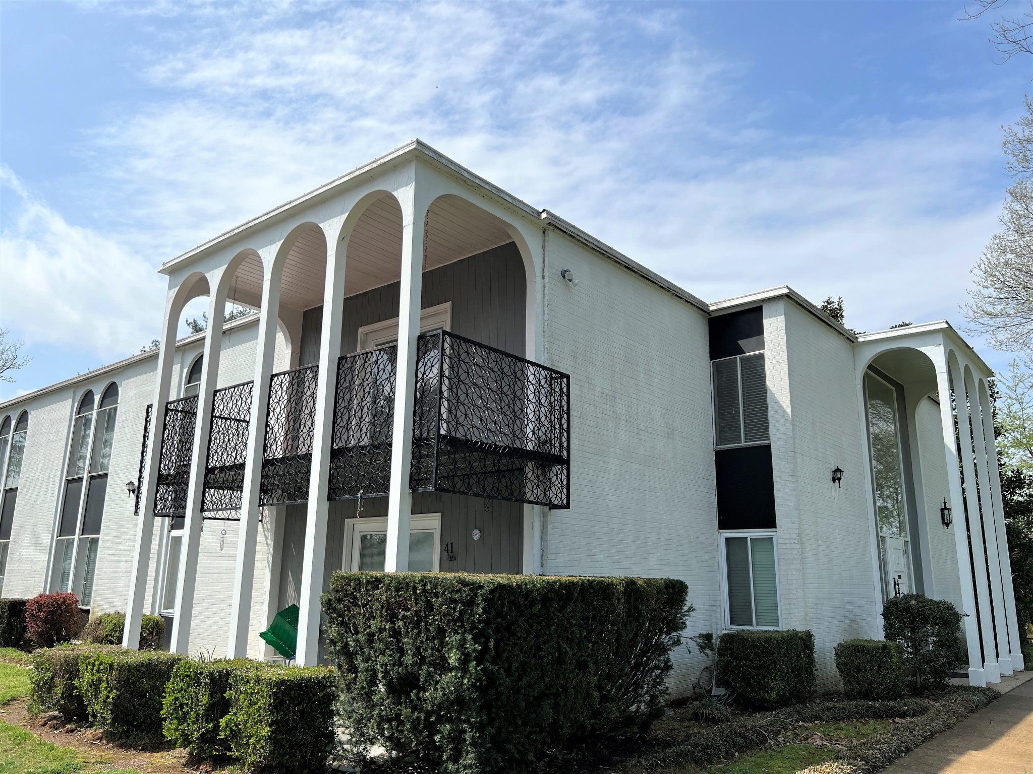 a front view of a house with a garden