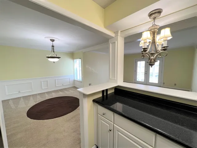 a kitchen with stainless steel appliances granite countertop a refrigerator a stove and a sink with wooden floor