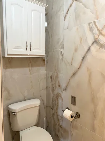 a bathroom with a toilet and shower