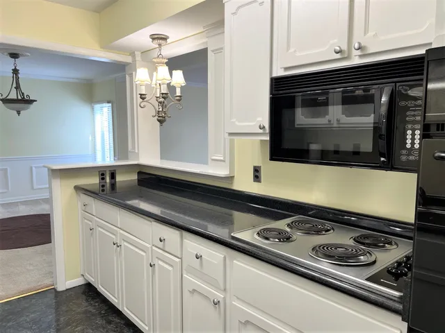 a kitchen with stainless steel appliances granite countertop a sink and cabinets