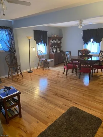 a living room filled with furniture and a wooden floor