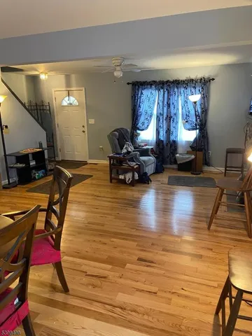a living room with furniture window and a wooden floor