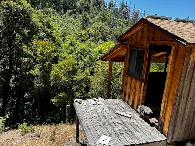 a backyard of a house with table and chairs