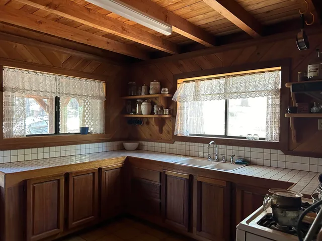 a kitchen with a sink stove and cabinets