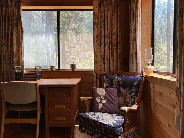 a view of a workspace with furniture and a bookshelf