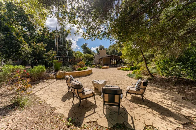 a view of a patio with table and chairs and potted plants